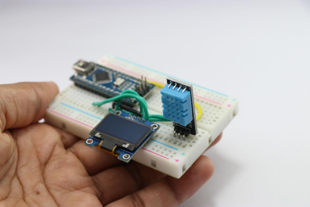 ESP32 Smart Monitoring System components including sensor module and breadboard